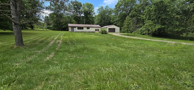 30127 Wells St, Dowagiac, MI 49047 - view of green lawn with a detached garage and an outdoor structure