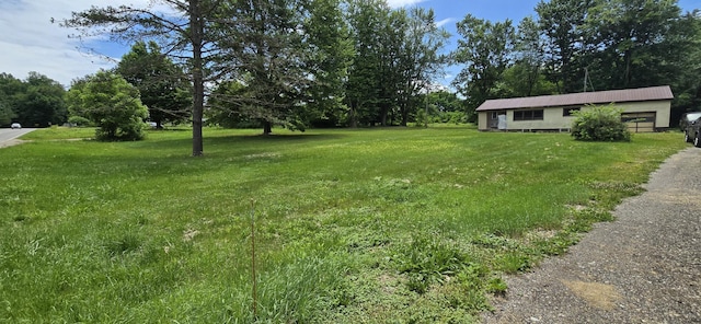 30127 Wells St, Dowagiac, MI 49047 - view of grassy yard with an attached garage