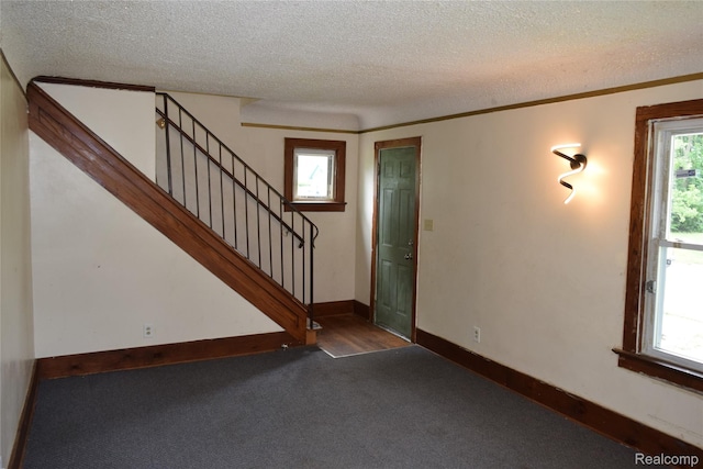 316 W Rankin St, Flint, MI 48505 - carpeted spare room with a textured ceiling and stairs