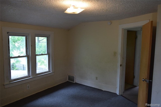 316 W Rankin St, Flint, MI 48505 - empty room with dark colored carpet, a textured ceiling, and a smoke detector