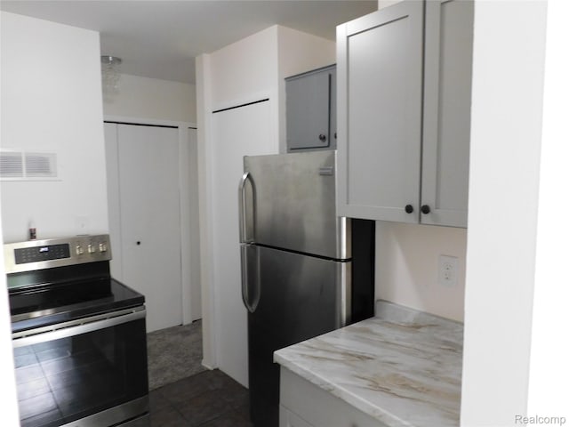 30268 Southfield Rd Unit 229, Southfield, MI 48076 - kitchen with appliances with stainless steel finishes, light stone counters, and dark carpet