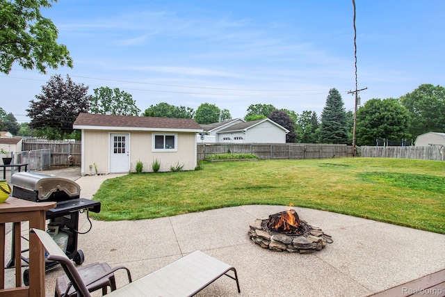 8406 W Ellis Rd, Davisburg, MI 48350 - fenced backyard featuring a fire pit, a patio, area for grilling, and an outdoor structure