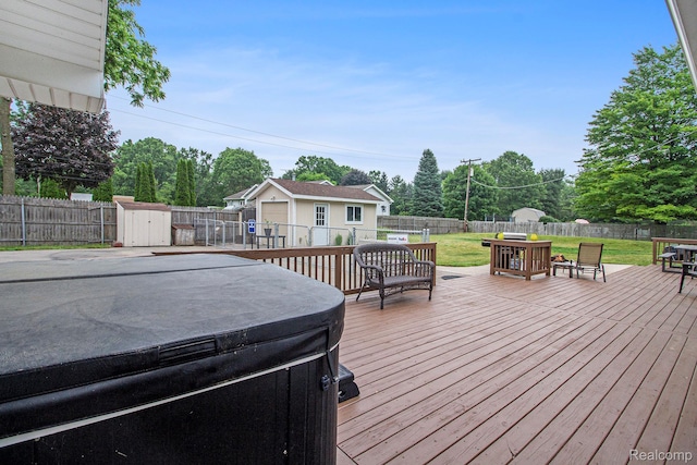 8406 W Ellis Rd, Davisburg, MI 48350 - deck featuring a hot tub, a fenced backyard, a storage unit, outdoor dining space, and view of wooded area