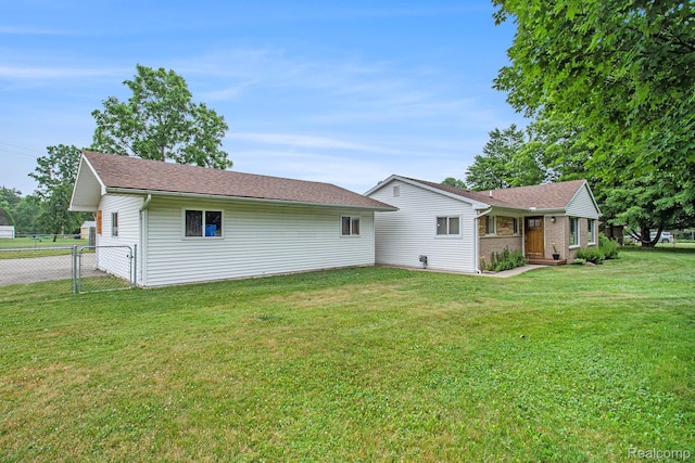 8406 W Ellis Rd, Davisburg, MI 48350 - back of property featuring roof with shingles and brick siding