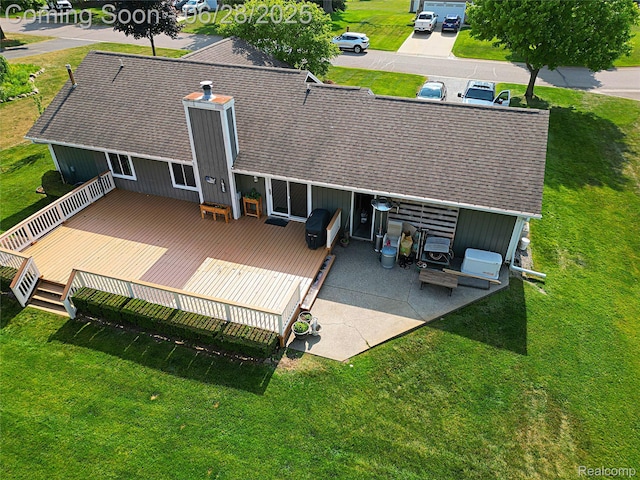 1640 High Pointe Dr, Commerce Twp, MI 48390 - back of house with a wooden deck, a yard, and a shingled roof