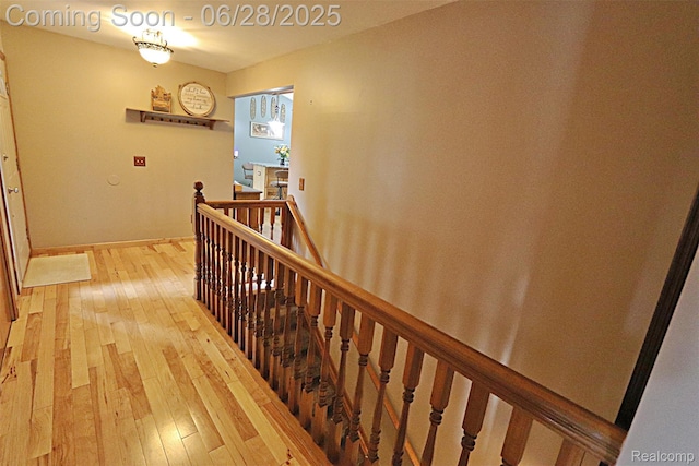 1640 High Pointe Dr, Commerce Twp, MI 48390 - hallway with an upstairs landing and light wood-type flooring