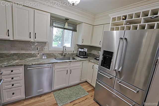 1640 High Pointe Dr, Commerce Twp, MI 48390 - kitchen with stainless steel appliances, tasteful backsplash, white cabinets, light wood-style floors, and ornamental molding