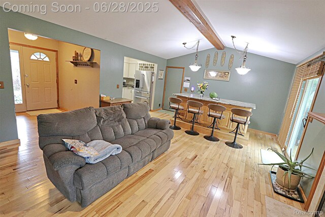 1640 High Pointe Dr, Commerce Twp, MI 48390 - living room with hardwood / wood-style floors and bar with sink