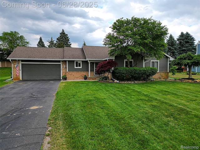 1640 High Pointe Dr, Commerce Twp, MI 48390 - view of front facade featuring brick siding, asphalt driveway, a front yard, and a garage
