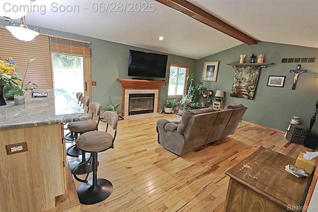 1640 High Pointe Dr, Commerce Twp, MI 48390 - living area featuring plenty of natural light, light wood finished floors, a fireplace with flush hearth, and recessed lighting