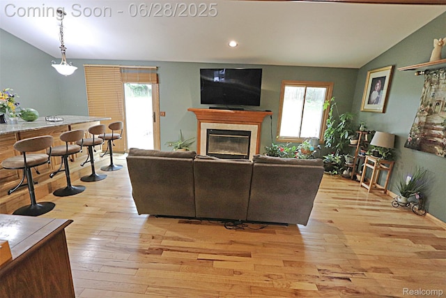 1640 High Pointe Dr, Commerce Twp, MI 48390 - living room featuring vaulted ceiling, light wood-style flooring, a fireplace, and recessed lighting
