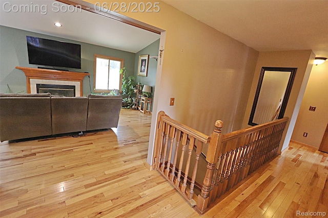 1640 High Pointe Dr, Commerce Twp, MI 48390 - stairs with hardwood / wood-style floors, a fireplace, and recessed lighting