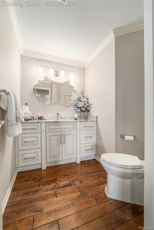 7590 Acorn Hill Ct, West Bloomfield, MI 48323 - half bathroom featuring ornamental molding, vanity, and wood finished floors