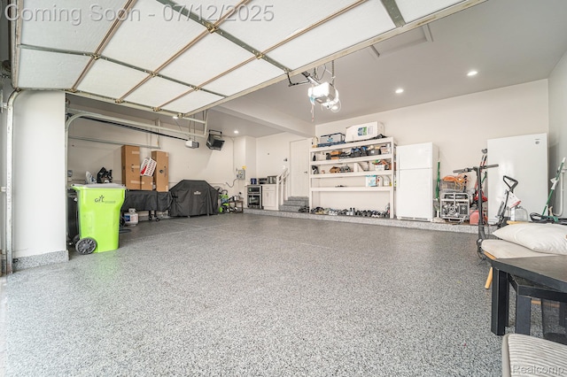 7590 Acorn Hill Ct, West Bloomfield, MI 48323 - garage featuring freestanding refrigerator and a garage door opener