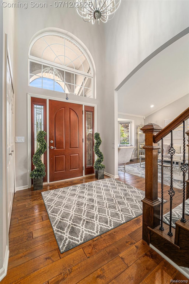 7590 Acorn Hill Ct, West Bloomfield, MI 48323 - foyer entrance with wood-type flooring, a towering ceiling, stairway, and a chandelier
