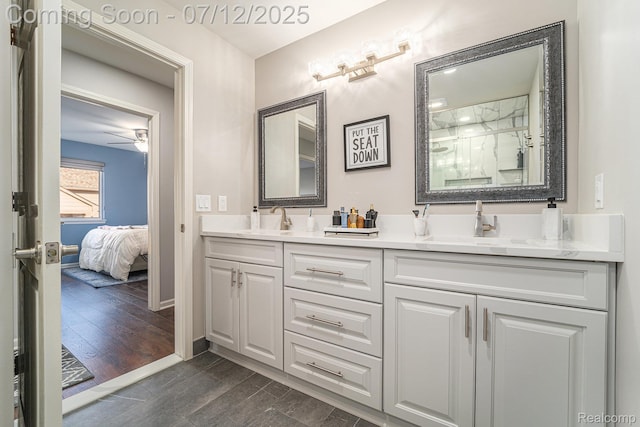 7590 Acorn Hill Ct, West Bloomfield, MI 48323 - ensuite bathroom with double vanity, a shower with shower door, wood finished floors, and a ceiling fan