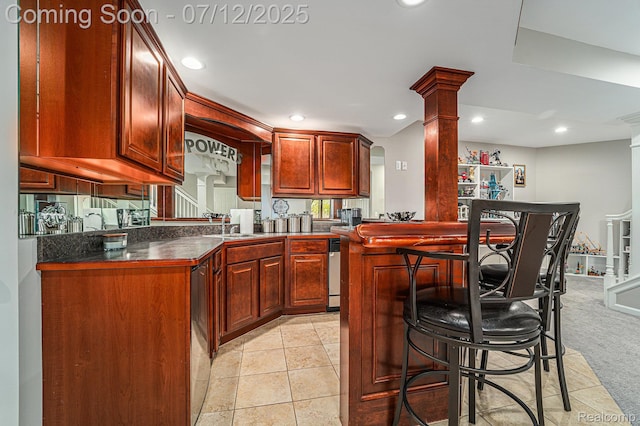 7590 Acorn Hill Ct, West Bloomfield, MI 48323 - kitchen with dark countertops, recessed lighting, decorative columns, a kitchen bar, and light tile patterned floors