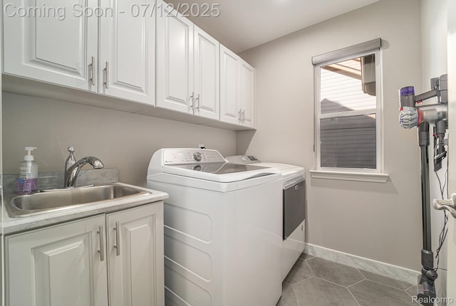 7590 Acorn Hill Ct, West Bloomfield, MI 48323 - washroom with washer and clothes dryer, cabinet space, and light tile patterned floors
