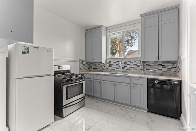 1518 Austin Ave, Lincoln Park, MI 48146 - kitchen featuring freestanding refrigerator, black dishwasher, stainless steel gas range oven, gray cabinets, and light marble finish floors