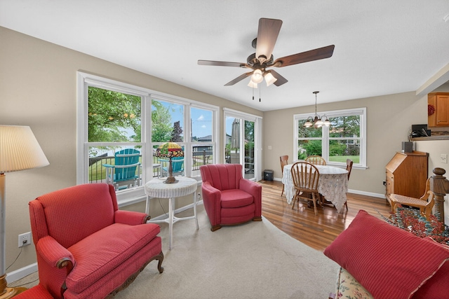70749 Sunset Blvd, Union, MI 49130 - living room with a chandelier, a ceiling fan, and wood finished floors