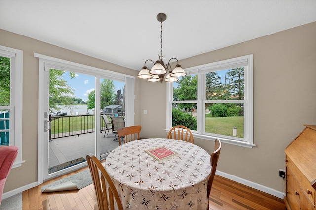 70749 Sunset Blvd, Union, MI 49130 - dining room featuring a chandelier, light wood-type flooring, and a water view