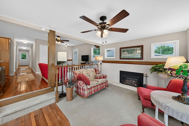 70749 Sunset Blvd, Union, MI 49130 - living area with wood finished floors, a fireplace, and a ceiling fan