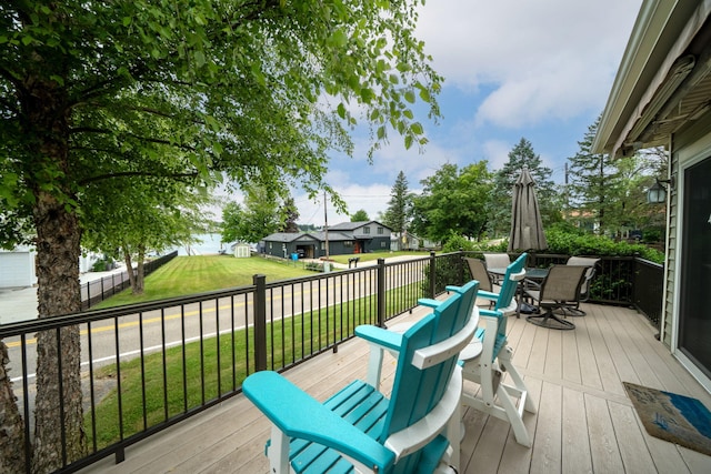 70749 Sunset Blvd, Union, MI 49130 - wooden deck featuring outdoor dining area, a lawn, and a residential view