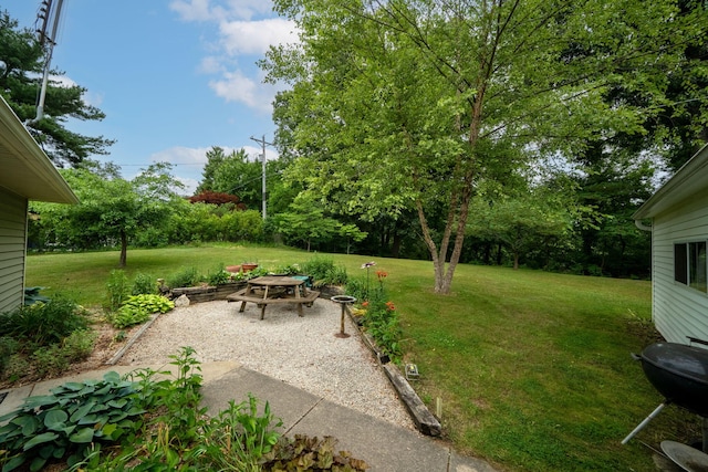 70749 Sunset Blvd, Union, MI 49130 - view of green lawn featuring an outdoor fire pit and a patio