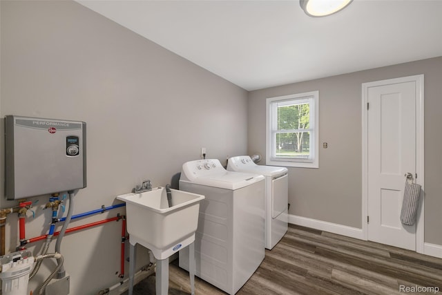 6590 Swartout Rd, Clay, MI 48001 - washroom with washer and dryer, tankless water heater, and wood finished floors