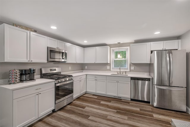 6590 Swartout Rd, Clay, MI 48001 - kitchen with appliances with stainless steel finishes, light countertops, white cabinets, and recessed lighting