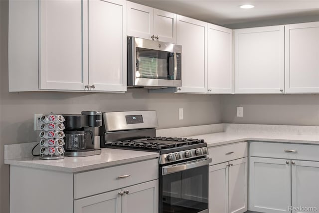 6590 Swartout Rd, Clay, MI 48001 - kitchen with stainless steel appliances, light countertops, white cabinetry, and recessed lighting