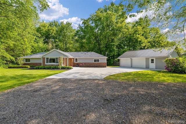 6590 Swartout Rd, Clay, MI 48001 - ranch-style home with driveway, an outbuilding, a front lawn, brick siding, and a garage