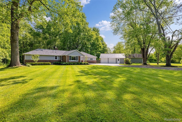 6590 Swartout Rd, Clay, MI 48001 - back of house featuring a garage, a chimney, brick siding, driveway, and a yard