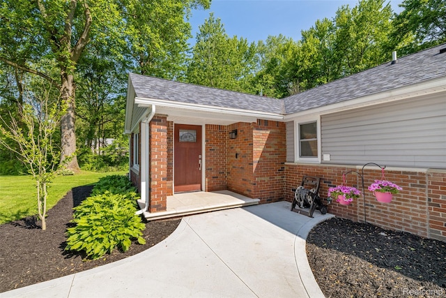 6590 Swartout Rd, Clay, MI 48001 - entrance to property featuring brick siding and roof with shingles