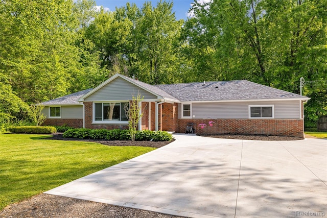 6590 Swartout Rd, Clay, MI 48001 - ranch-style home featuring brick siding, concrete driveway, and a front lawn