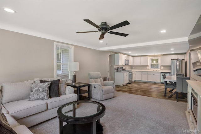 6590 Swartout Rd, Clay, MI 48001 - living area featuring a ceiling fan, recessed lighting, dark wood-style flooring, and dark colored carpet