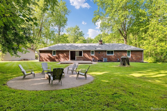 6590 Swartout Rd, Clay, MI 48001 - rear view of property with a patio area, a fire pit, and brick siding