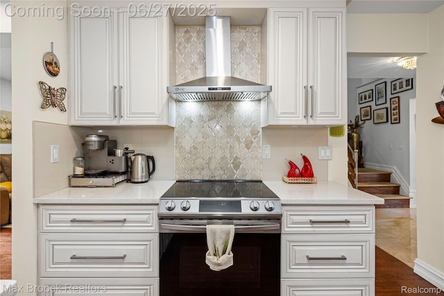 31723 Forest Ln, Warren, MI 48093 - kitchen with wall chimney exhaust hood, electric range, white cabinets, and tasteful backsplash