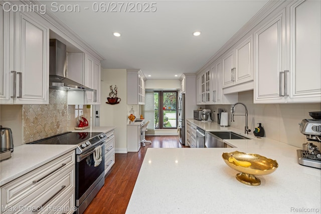 31723 Forest Ln, Warren, MI 48093 - kitchen featuring appliances with stainless steel finishes, wall chimney exhaust hood, light countertops, dark wood-style floors, and recessed lighting