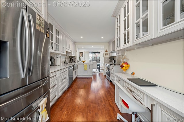 31723 Forest Ln, Warren, MI 48093 - kitchen with stainless steel appliances, dark wood-type flooring, glass insert cabinets, a peninsula, and recessed lighting