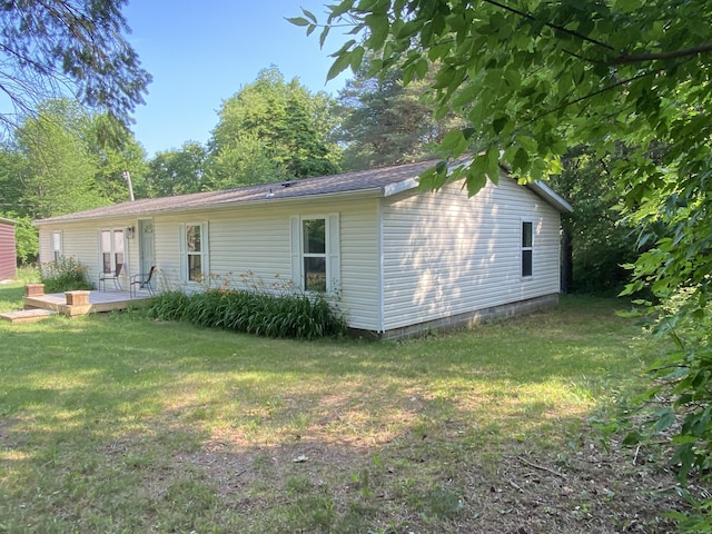 6317 E 76th St, Newaygo, MI 49337 - rear view of house featuring a yard
