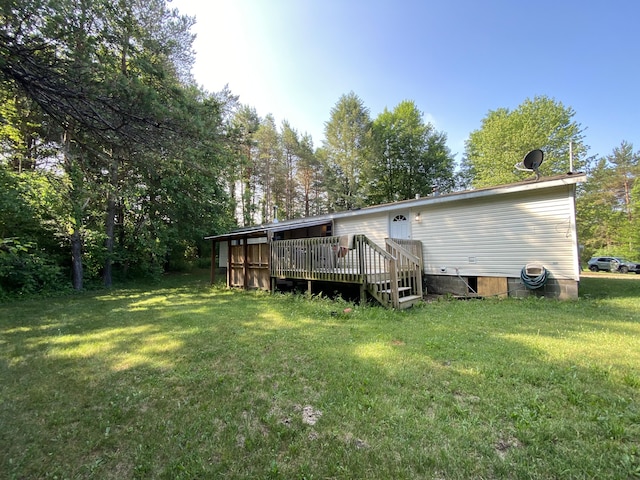 6317 E 76th St, Newaygo, MI 49337 - rear view of property featuring a yard and a deck