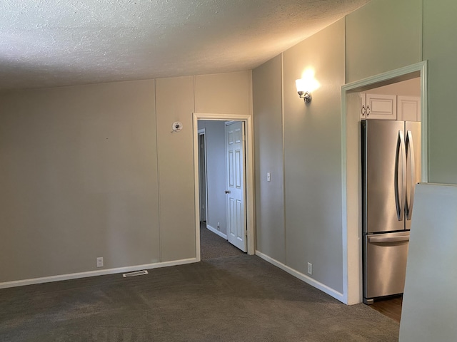 6317 E 76th St, Newaygo, MI 49337 - empty room with dark carpet and a textured ceiling