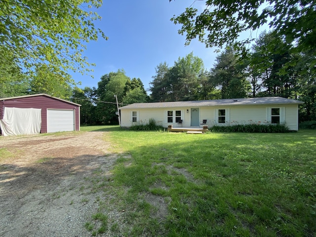 6317 E 76th St, Newaygo, MI 49337 - rear view of house with driveway, an outbuilding, a detached garage, and a yard