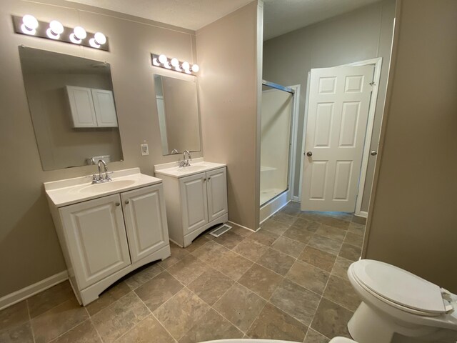 6317 E 76th St, Newaygo, MI 49337 - bathroom featuring a shower stall, two vanities, and stone finish flooring