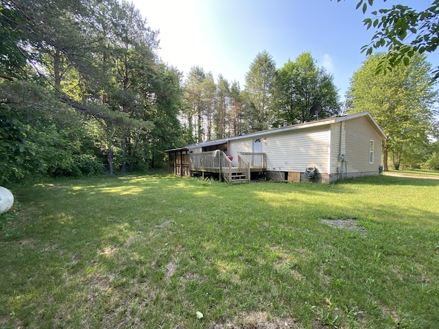 6317 E 76th St, Newaygo, MI 49337 - view of green lawn with a deck