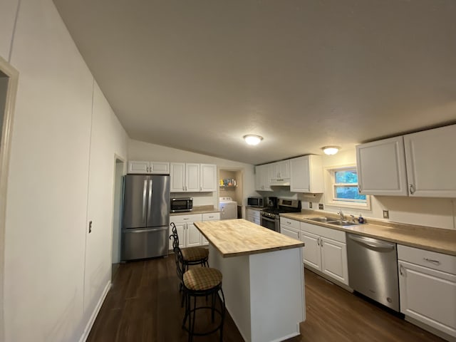 6317 E 76th St, Newaygo, MI 49337 - kitchen featuring stainless steel appliances, wood counters, white cabinetry, dark wood-style flooring, and a breakfast bar