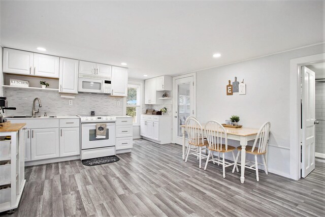20020 T Dr S, Tekonsha, MI 49092 - kitchen featuring white appliances, open shelves, light wood-style flooring, and recessed lighting