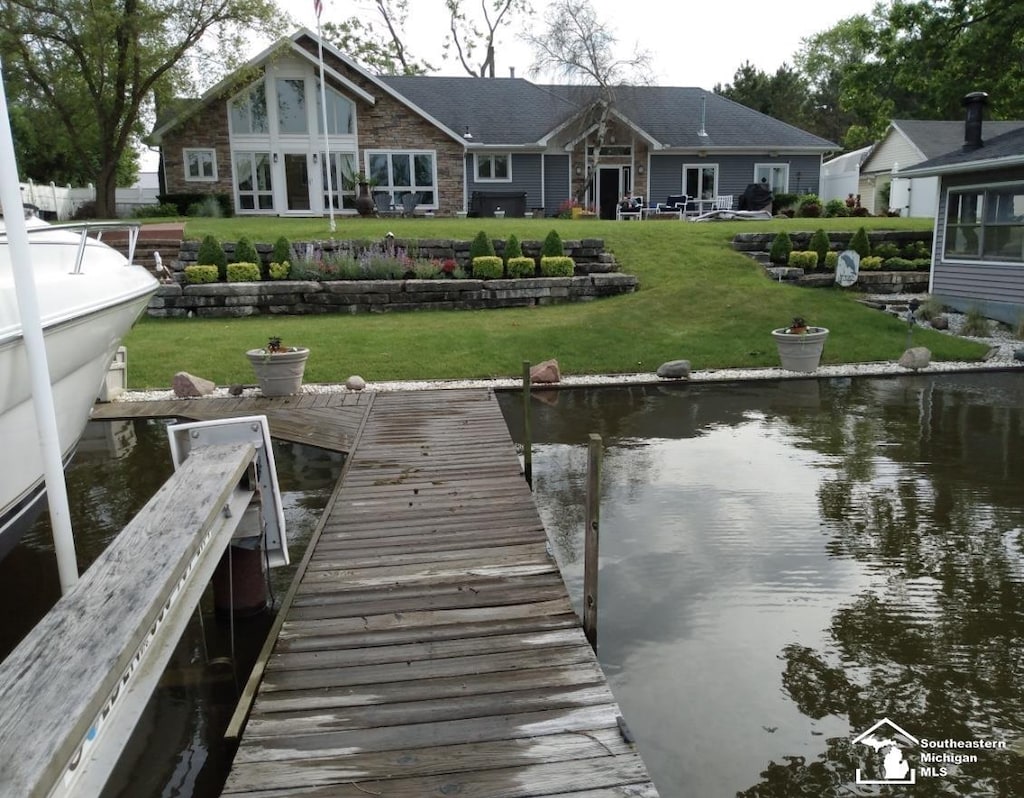 7322 Forrest Ln, Newport, MI 48166 - rear view of house with a water view, stone siding, and a yard
