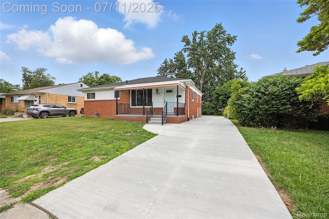 1418 W 13 Mile Rd, Royal Oak, MI 48073 - view of front of home featuring brick siding, a front yard, and a porch